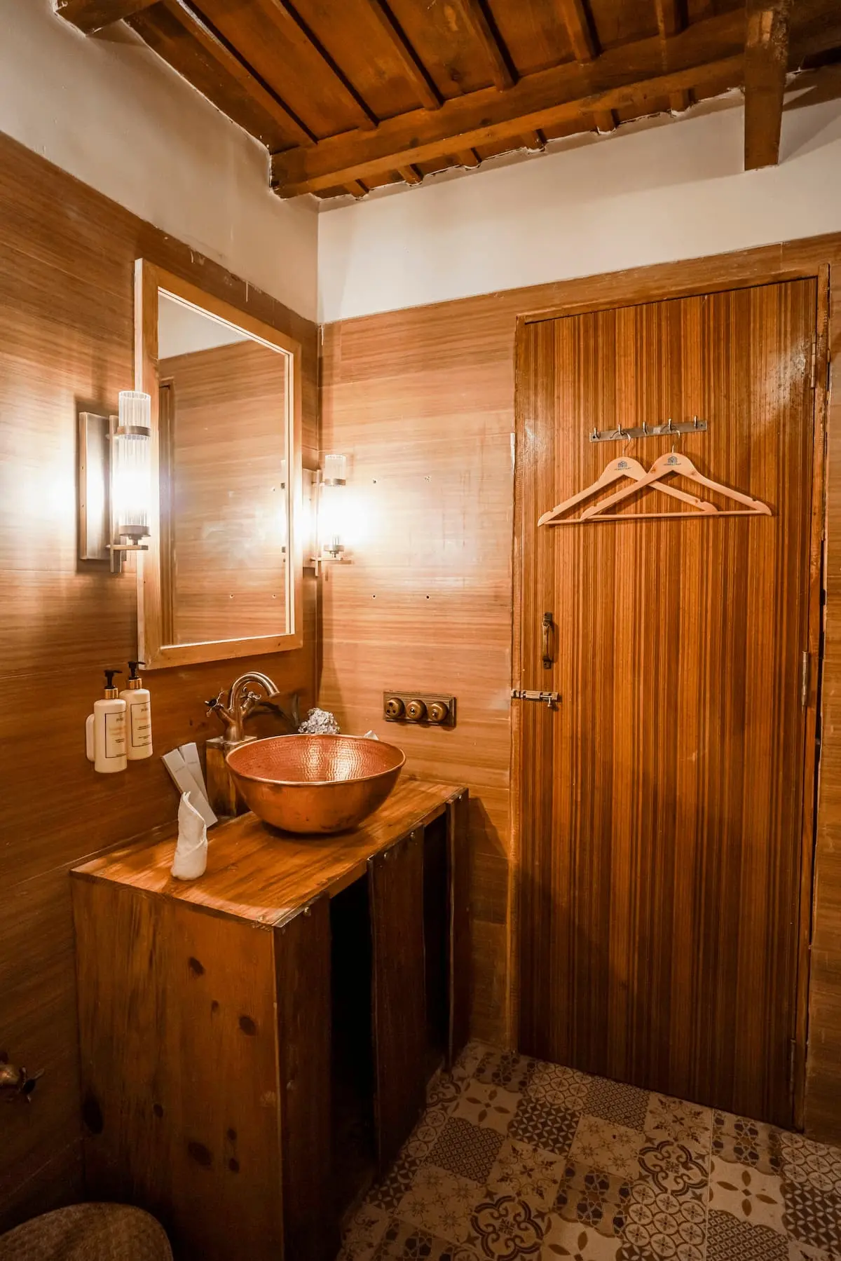 Copper basin bathroom with warm wood panelling in the Classic Heritage Room, Two Chimneys