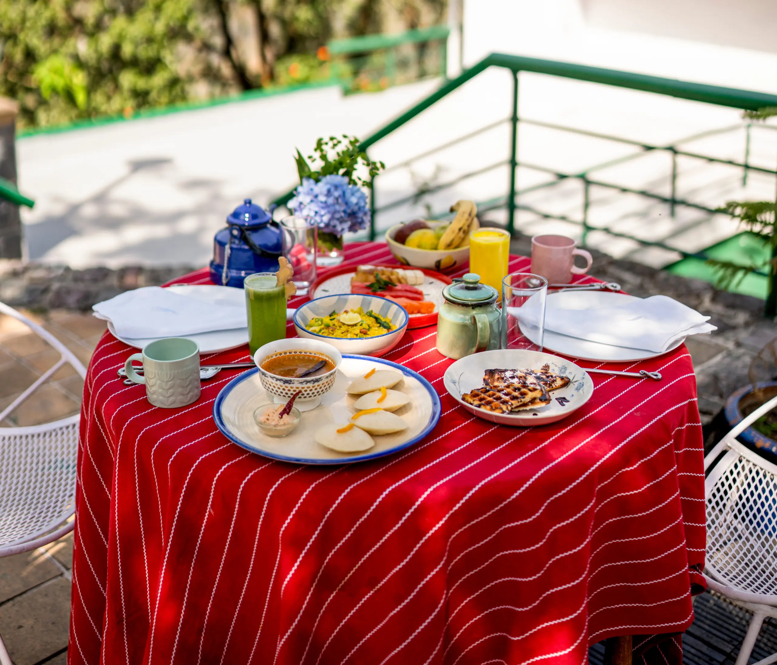 Kumaoni breakfast served on a terrace with mountain views at Two Chimneys, Gethia
